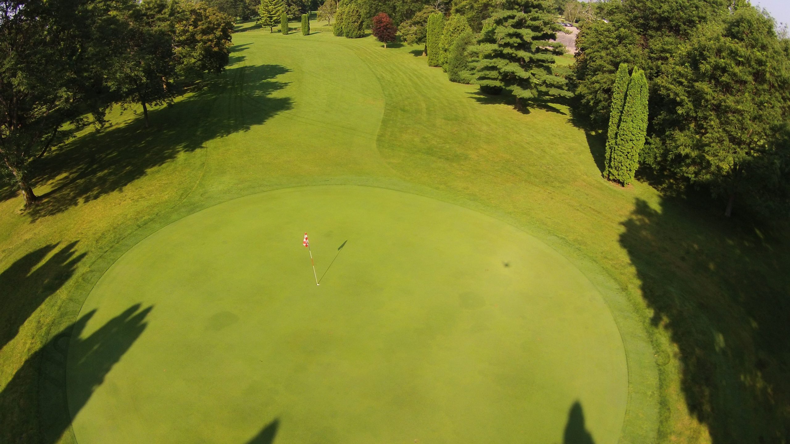 Aerial view of a green and tree-lined fairway at Columbus Country Club in Columbus, Wisconsin