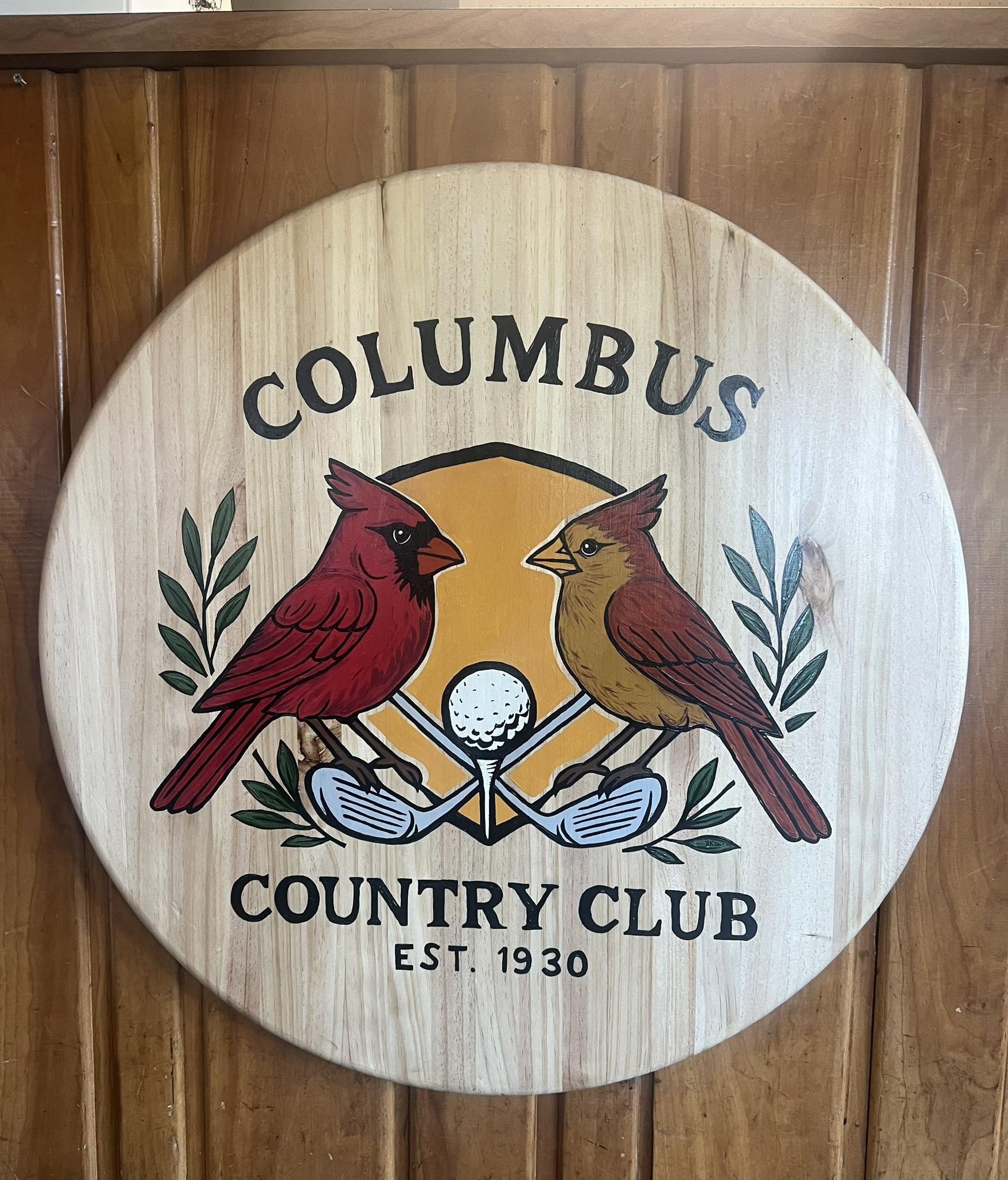 The Columbus Country Club wooden crest at the clubhouse check-in desk