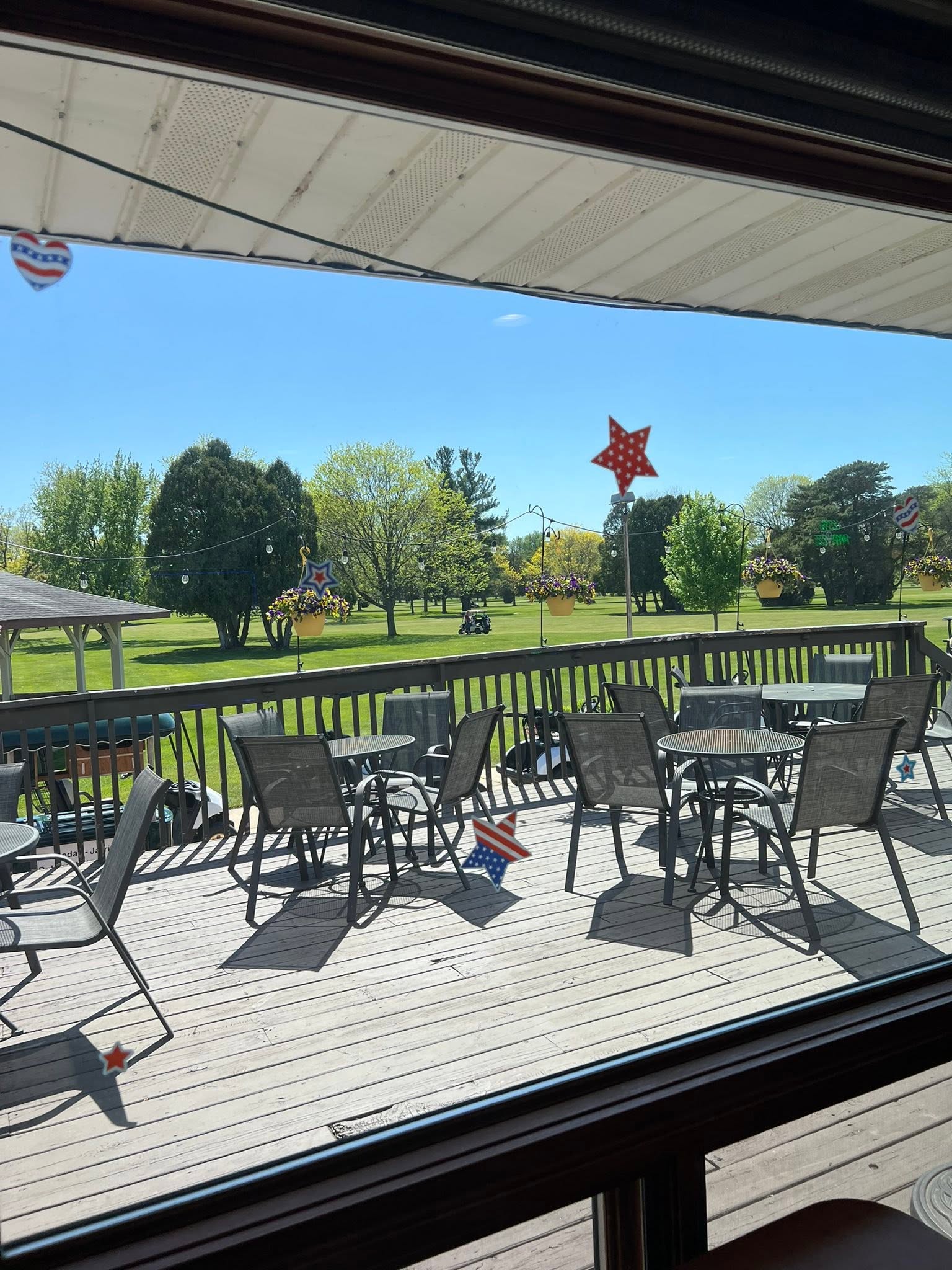 Tables and chairs on the Columbus Country Club deck overlooking the golf course