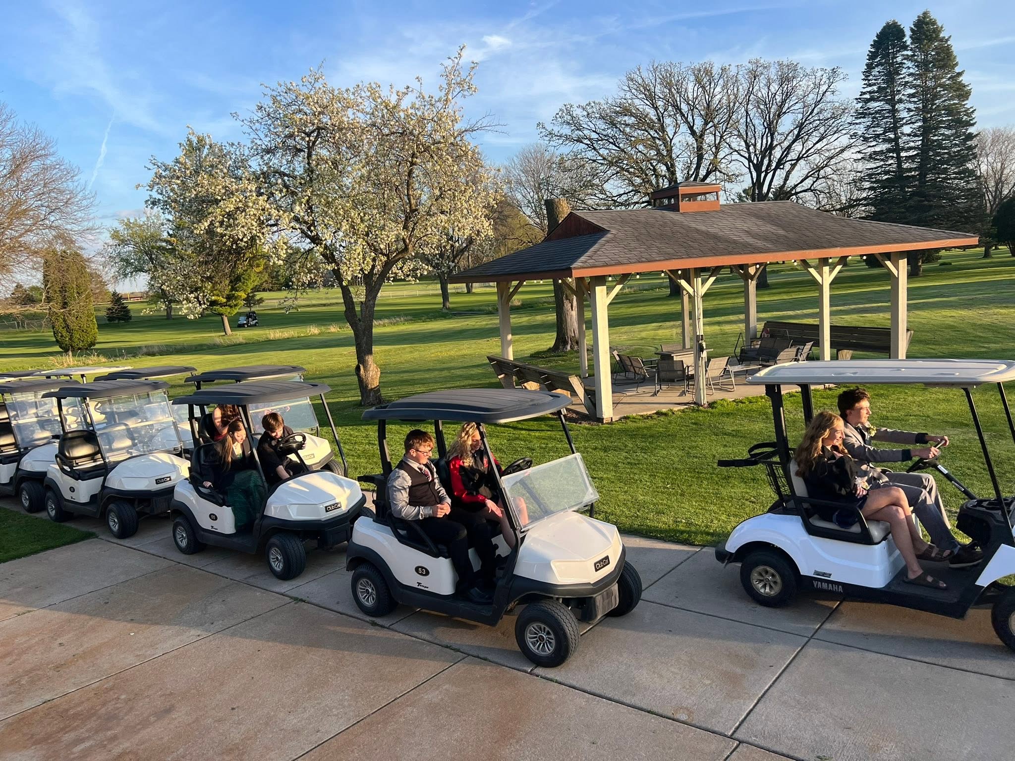 A group gathered in golf carts beside the gazebo at Columbus Country Club