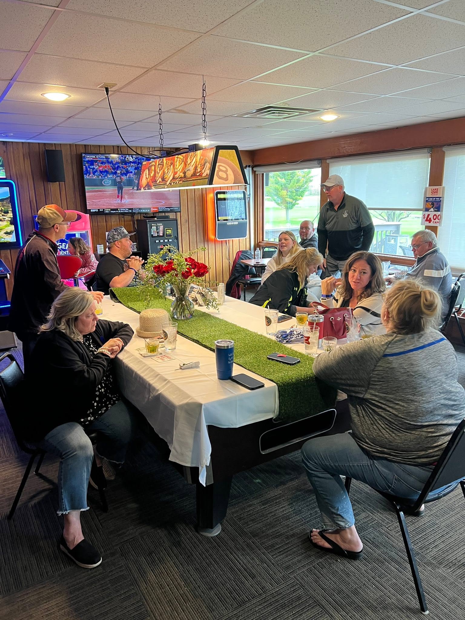 Guests seated around a long table in the Columbus Country Club bar area
